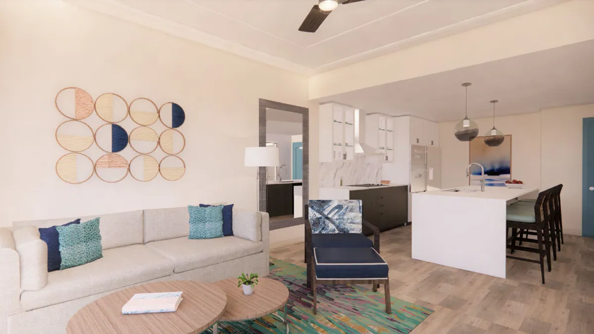The image reveals a stylish, modern interior featuring a spacious kitchen island perfect for gathering, comfortable seating for relaxation, and distinctive round wall art that adds a touch of personality. The setting feels airy and inviting, emphasizing space for socializing and unwinding.